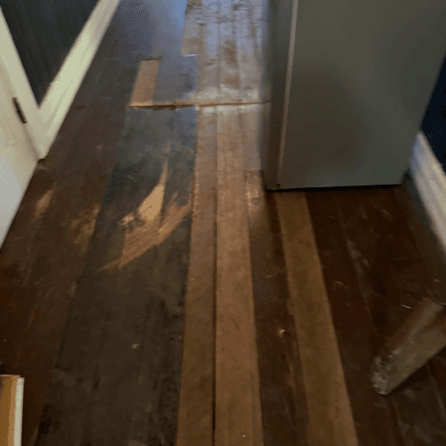 Damaged hardwood floors inside the house